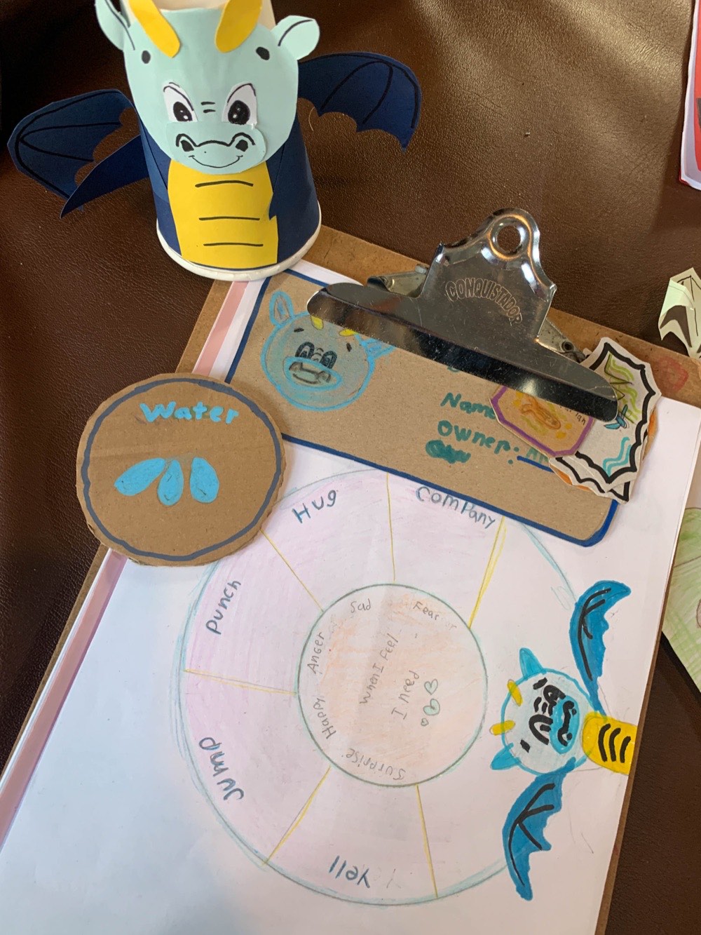 A child-made feelings wheel and paper dragon used in the Emotional Wheel Kit